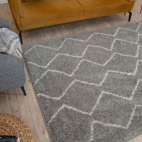 Moroccan grey shaggy rug with a geometric diamond pattern outlined in white perfect for cozy decor