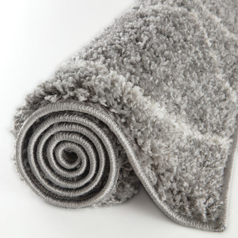A moroccan grey shaggy rug with a soft textured surface and neatly stitched edges perfect for cozy spaces