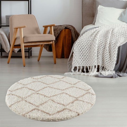 Cream-colored moroccan ivory beige circular rug with plush shaggy texture and subtle geometric diamond pattern