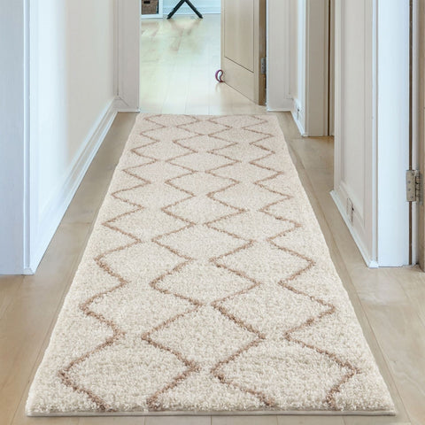Moroccan ivory beige shaggy runner rug with a cream base and beige geometric diamond pattern perfect for cozy spaces