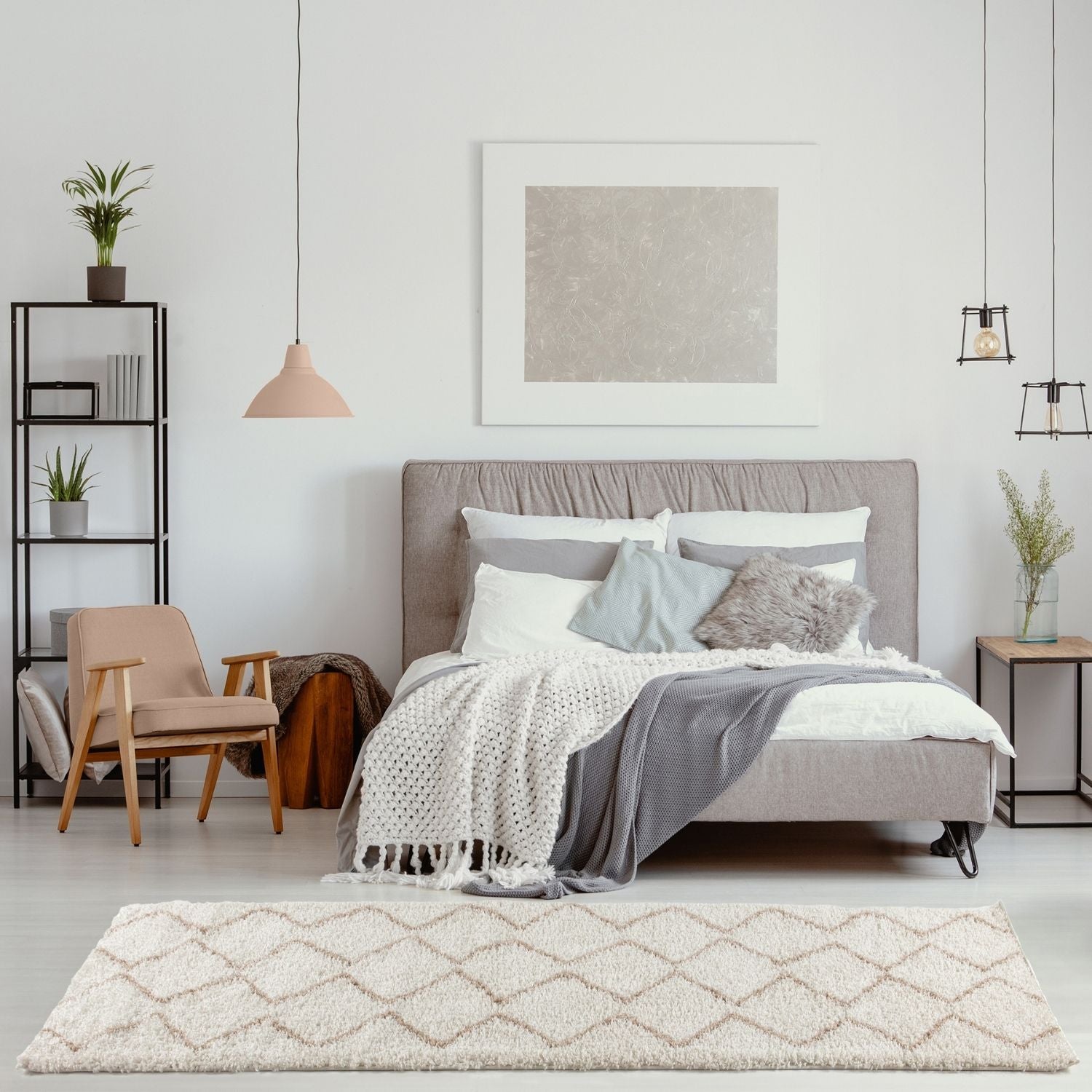 Gray upholstered bed with tufted headboard and layered pillows on a moroccan ivory beige shaggy rug 830