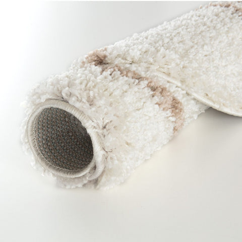A plush moroccan ivory beige shaggy rug with textured looped pile perfect for cozy home decor