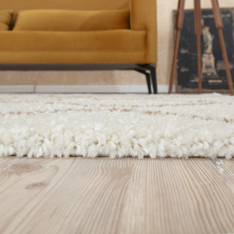 A moroccan ivory beige shaggy rug with soft fluffy texture on light wood flooring perfect for cozy spaces