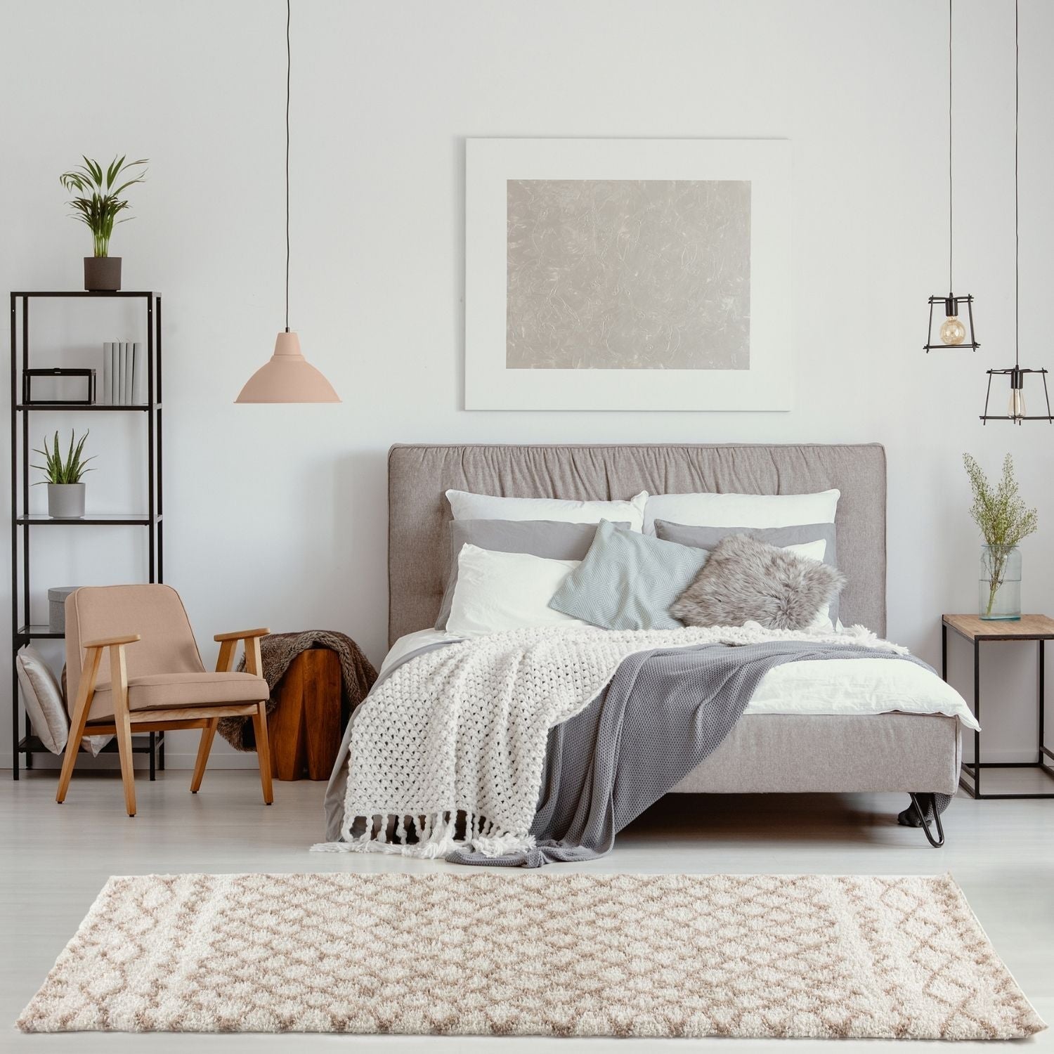 Gray upholstered bed with tufted headboard and layered bedding on a moroccan ivory beige shaggy rug