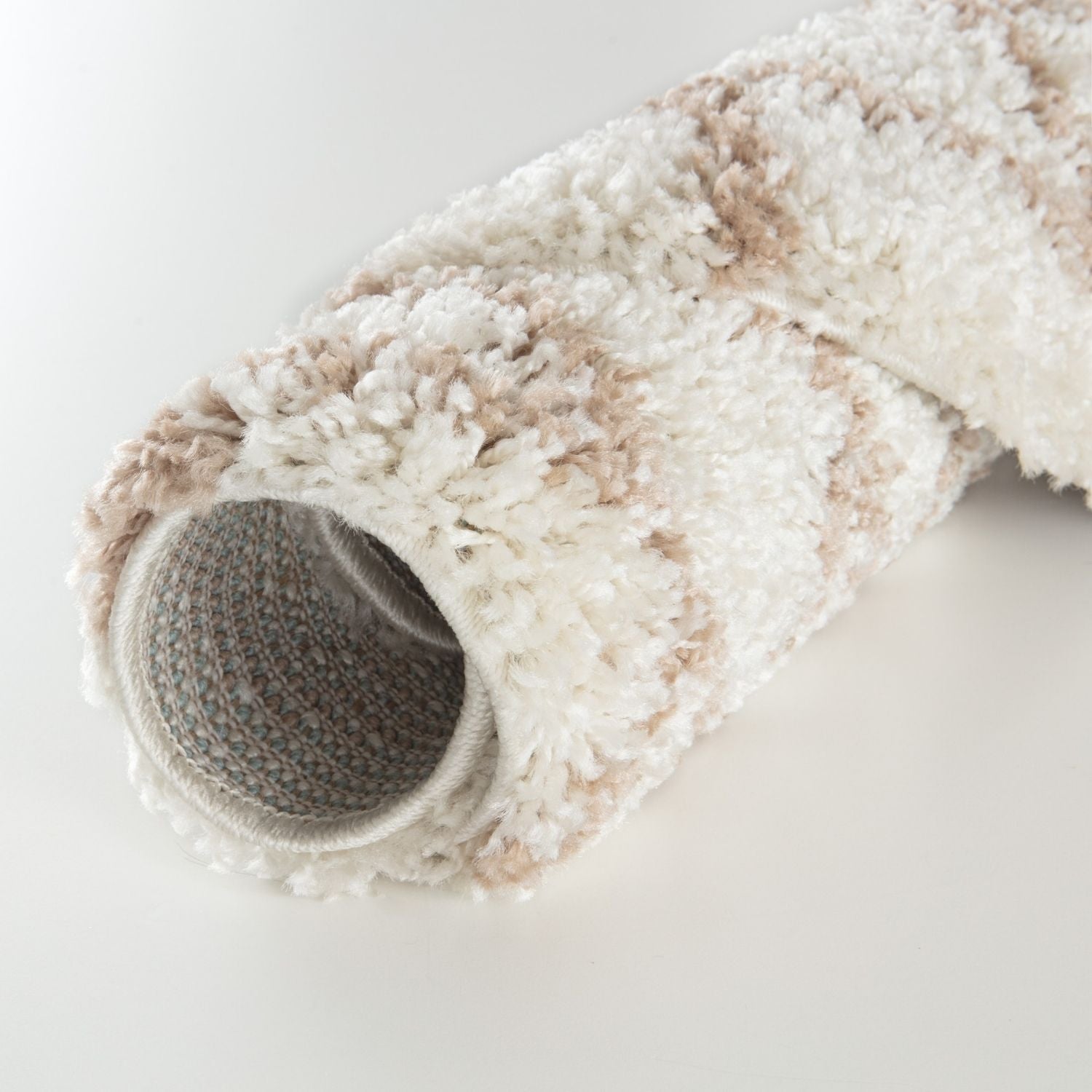 A moroccan ivory beige shaggy rug with a plush, soft textured surface in cream and beige tones