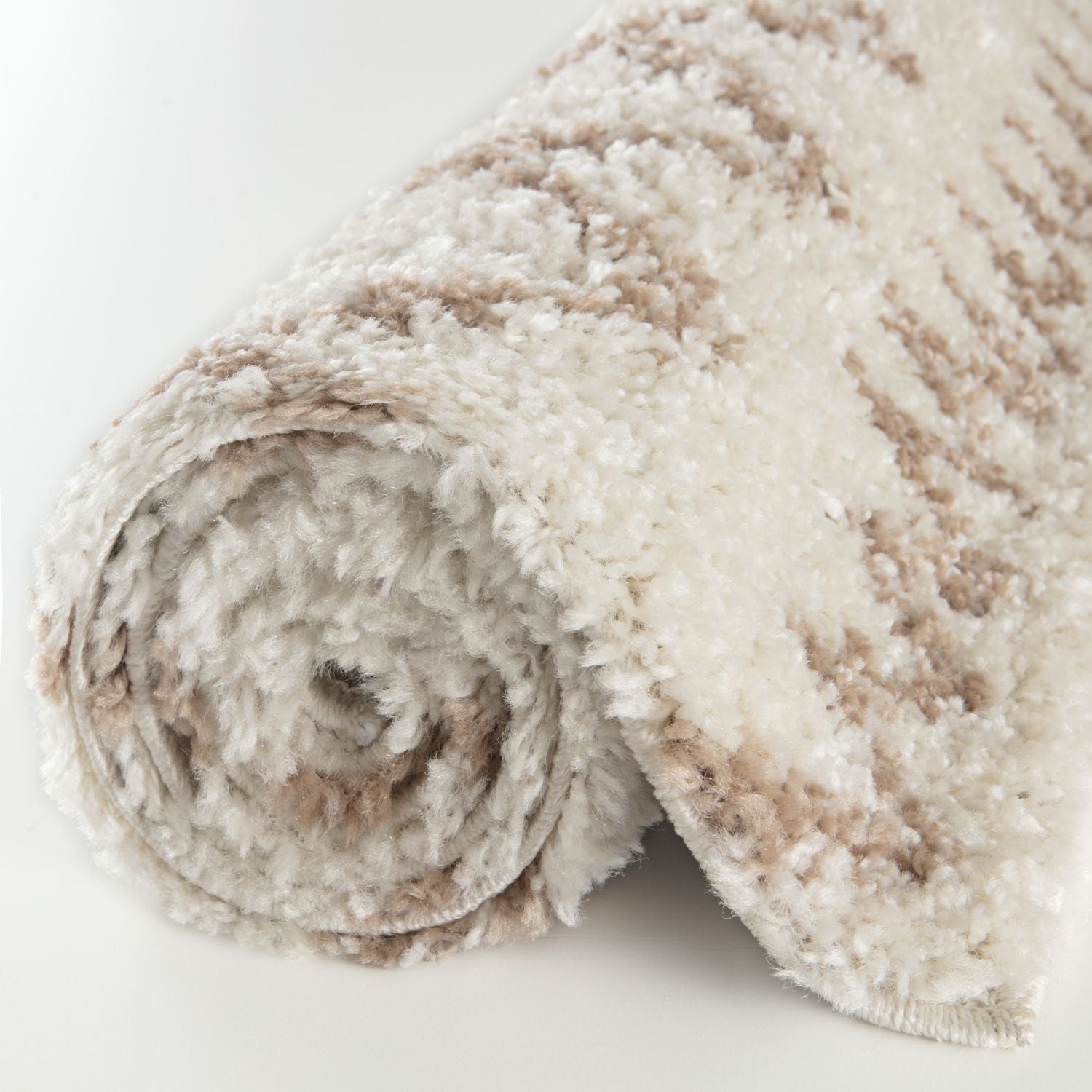 A plush moroccan ivory beige shaggy rug rolled up with soft white and beige stripes in fluffy textured material