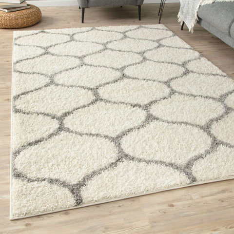 Cream-colored moroccan ivory shaggy rug with a gray geometric hexagonal pattern and soft shaggy texture