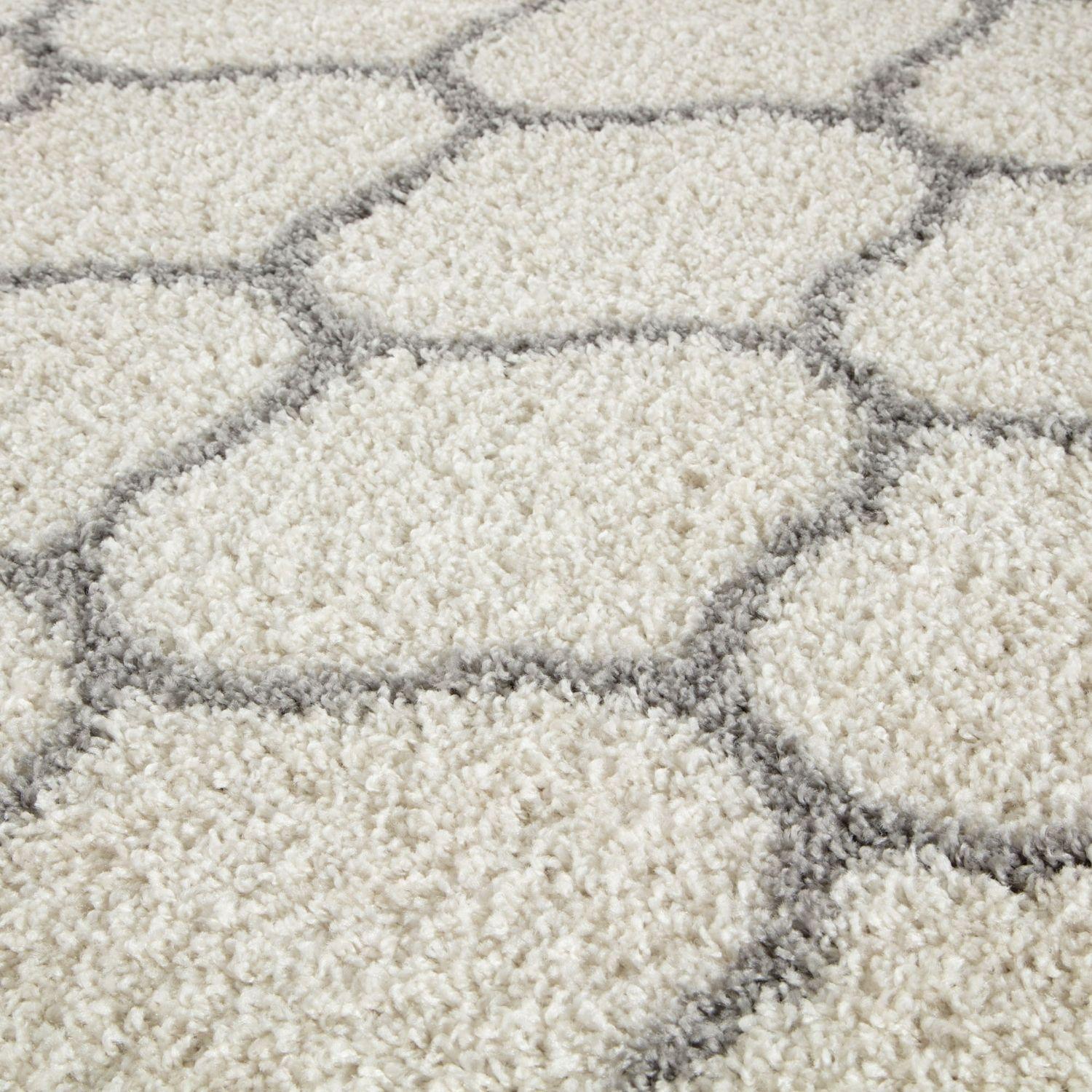 Cream-colored moroccan ivory shaggy rug with plush texture and gray hexagonal geometric pattern perfect for cozy spaces