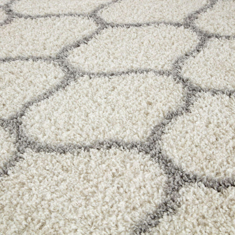 Cream-colored moroccan ivory shaggy rug with plush texture and gray hexagonal geometric pattern perfect for cozy spaces