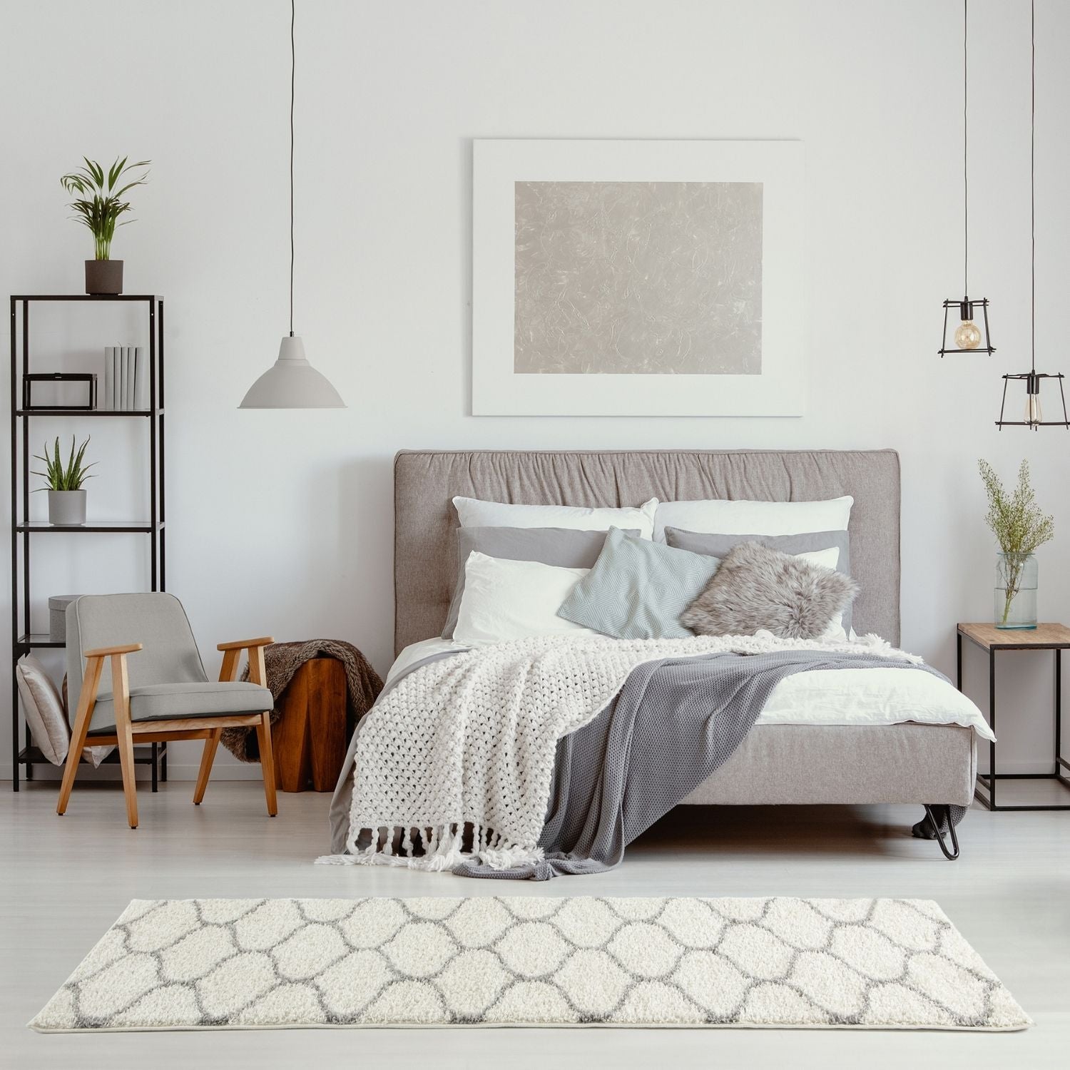 Gray upholstered bed with tufted headboard and layered bedding on a moroccan ivory shaggy rug 600 model