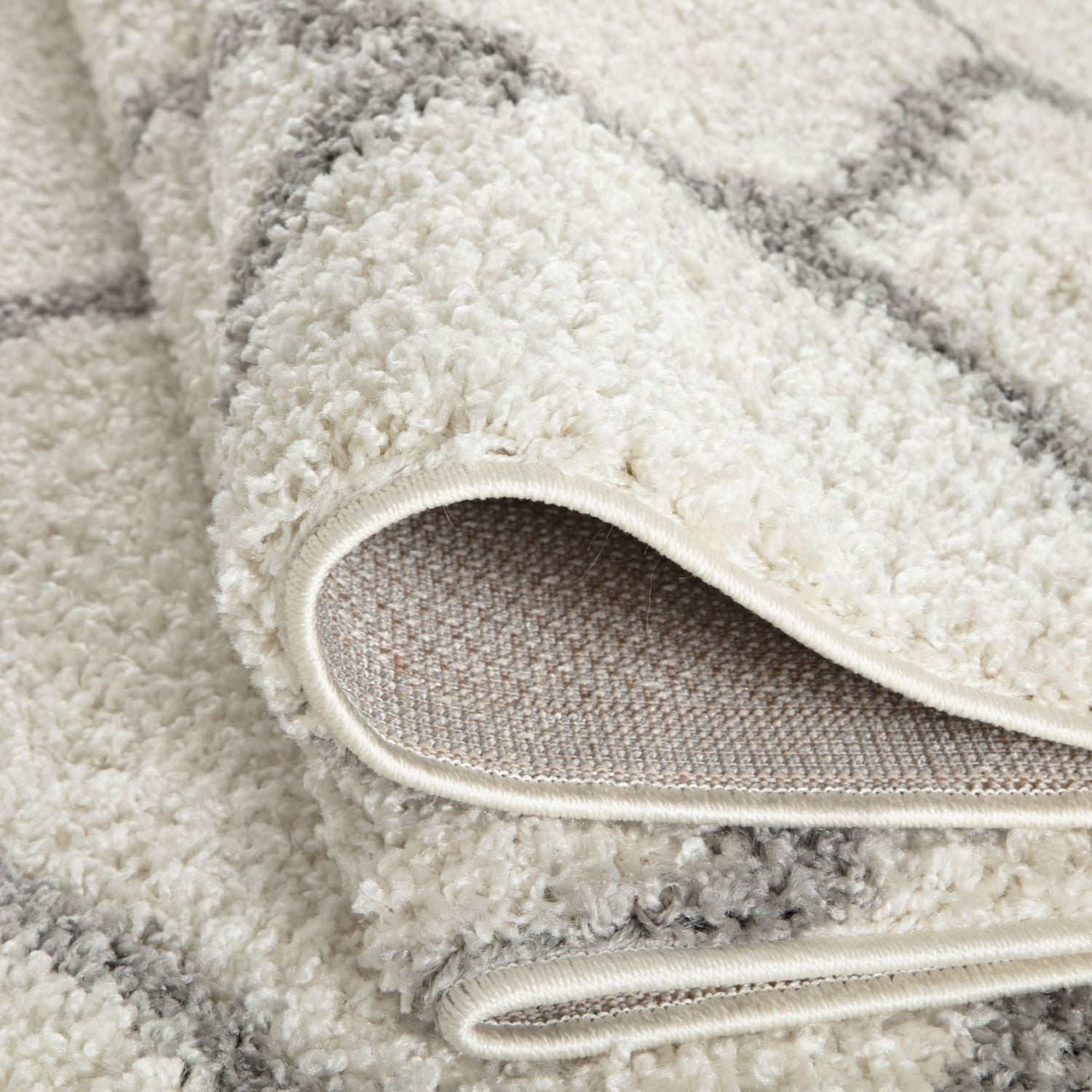 A moroccan ivory shaggy rug with plush cream and gray stripes and a soft textured surface perfect for cozy spaces