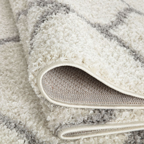 A moroccan ivory shaggy rug with plush cream and gray stripes and a soft textured surface perfect for cozy spaces