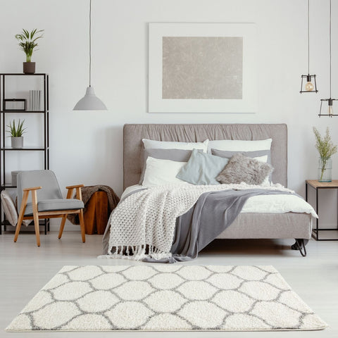 A plush moroccan ivory shaggy rug with white and gray geometric patterns and a soft shaggy texture