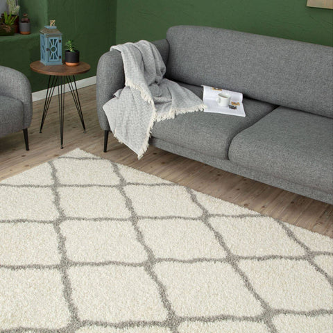 Moroccan ivory shaggy rug with a cream-colored shag and geometric gray grid pattern for cozy decor