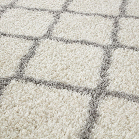 Moroccan ivory shaggy rug with cream color, soft plush texture, and subtle gray geometric grid pattern