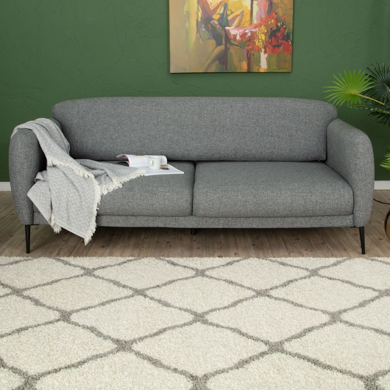 Gray textured fabric sofa with black legs paired with moroccan ivory shaggy ivory shaggy rug for cozy style