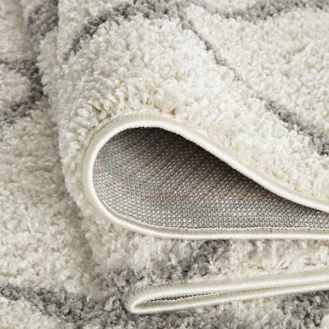 A plush moroccan ivory shaggy rug with cream and gray tones and a soft textured surface for cozy spaces