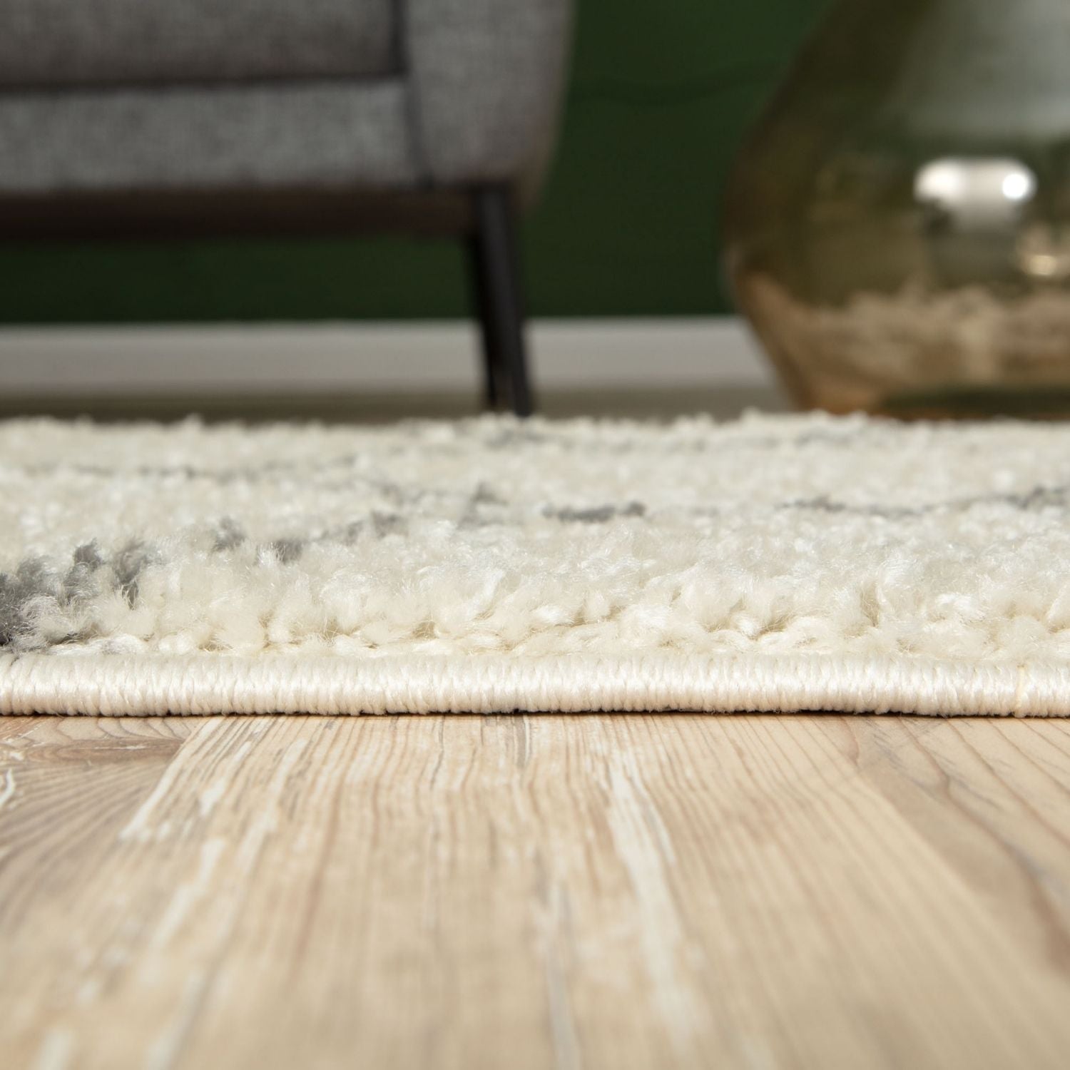 A plush moroccan ivory shaggy rug with off-white texture and subtle gray accents along the edges