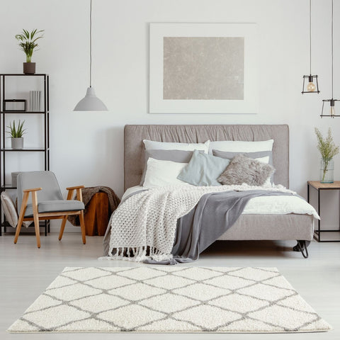 A plush moroccan ivory shaggy rug with a gray geometric diamond pattern for cozy home decor