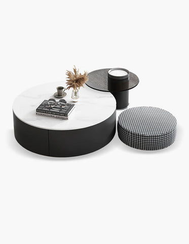 Modern black and white round nesting coffee table with a marble top and sleek cylindrical base for stylish living rooms
