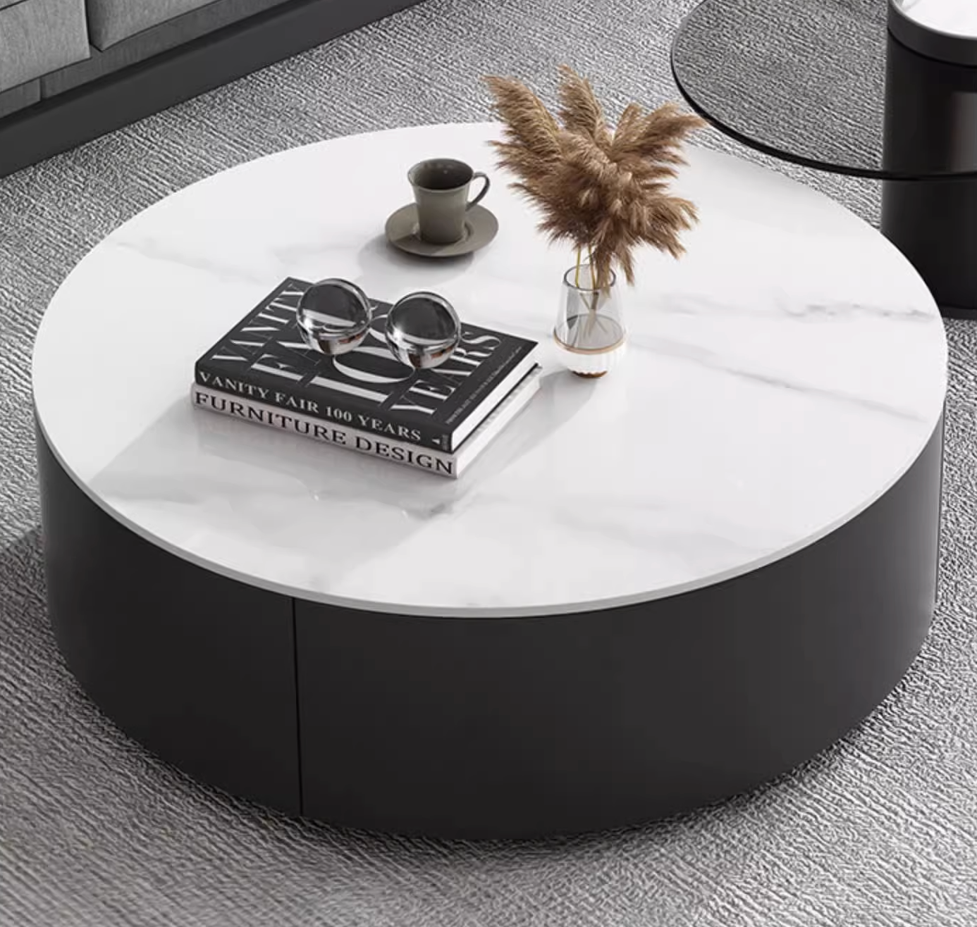 Modern round nesting coffee table with white marble top and sleek black base in mosaic set with ottoman