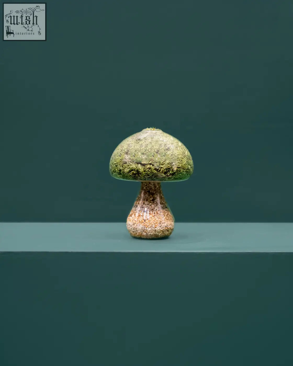 A moss mushroom figurine made of natural stone with preserved moss covering its textured earthy-toned cap and stem