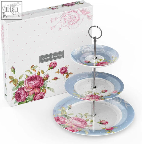 Three tier cake stand with pink rose and green leaf patterns on light blue plates and silver metal column
