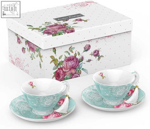 A turquoise porcelain teacup and saucer with pink floral patterns and tassel perfect for a tier cake stand set