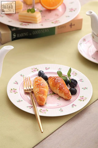 Pink floral ceramic plate with sesame croissants and gold fork part of mothers day tier cake stand set