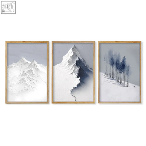 Set of three mountain painting prints featuring snowy nordic peaks and forest in light wood frames for dining room decor