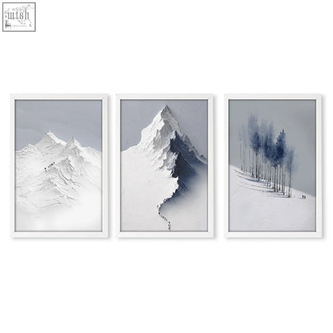 Set of three minimalist white-framed mountain painting prints featuring snowy nordic peaks and forest for dining room wall art