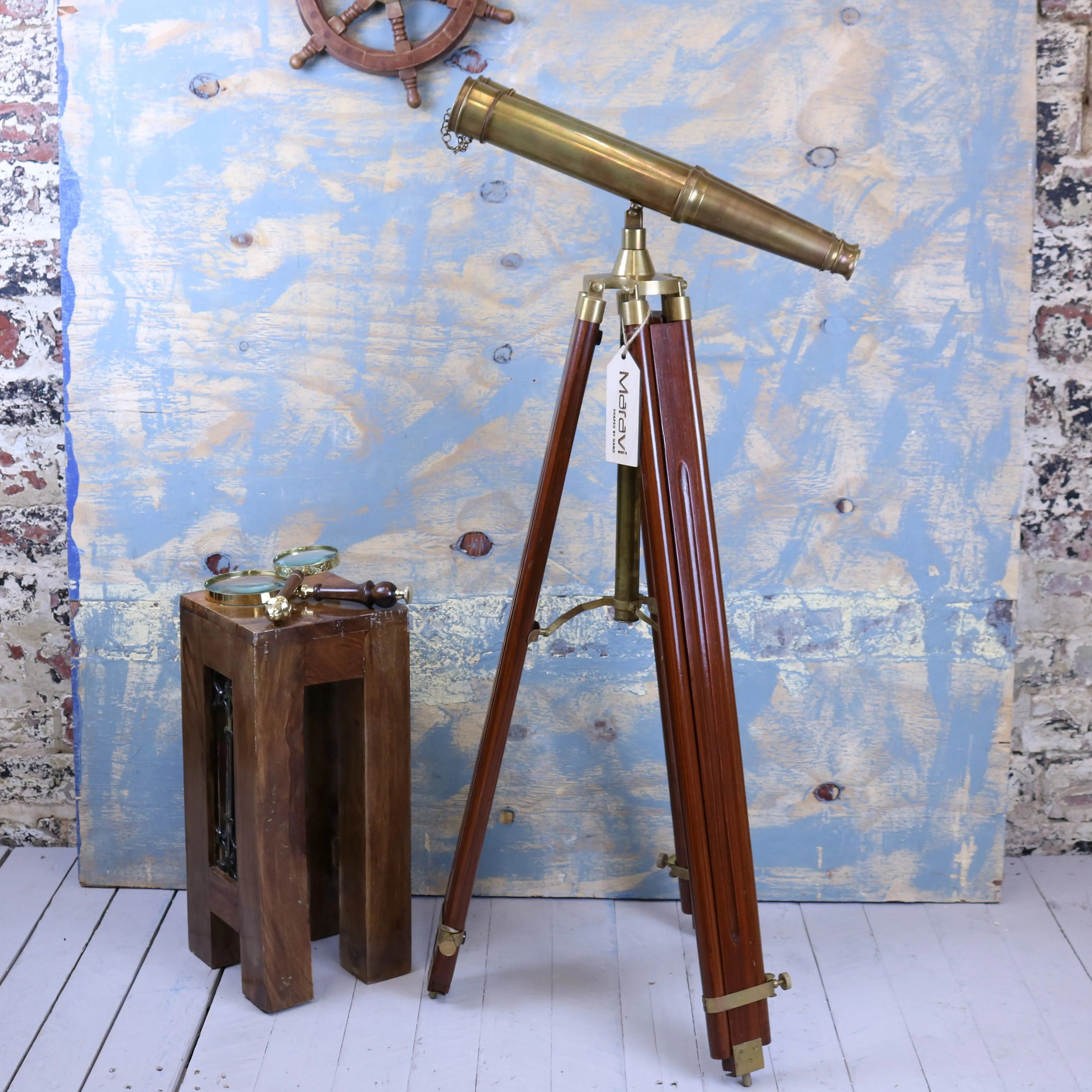 Antique brass mowai vintage binoculars mounted on polished wooden tripod for classic decor and display