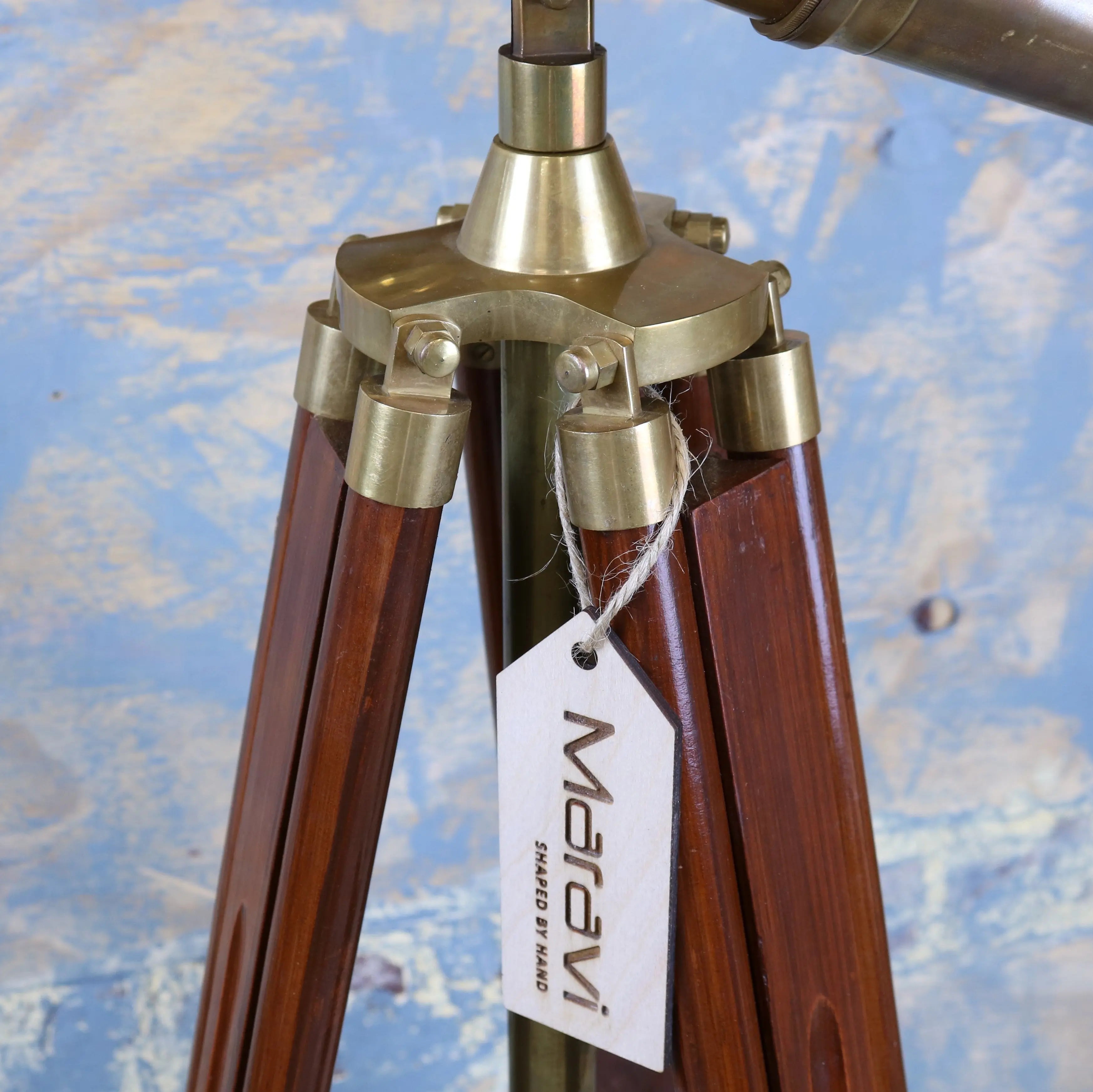 A brass-finished vintage binocular tripod with rich dark wood legs showcasing mowai vintage binoculars style