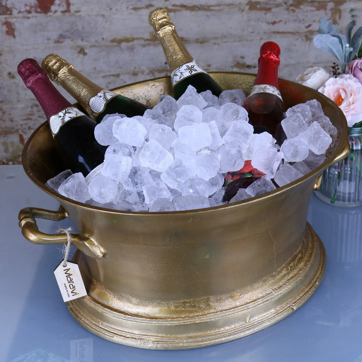 Gold-colored metallic moyar champagne bucket large ice bath with ornate handles and distressed finish