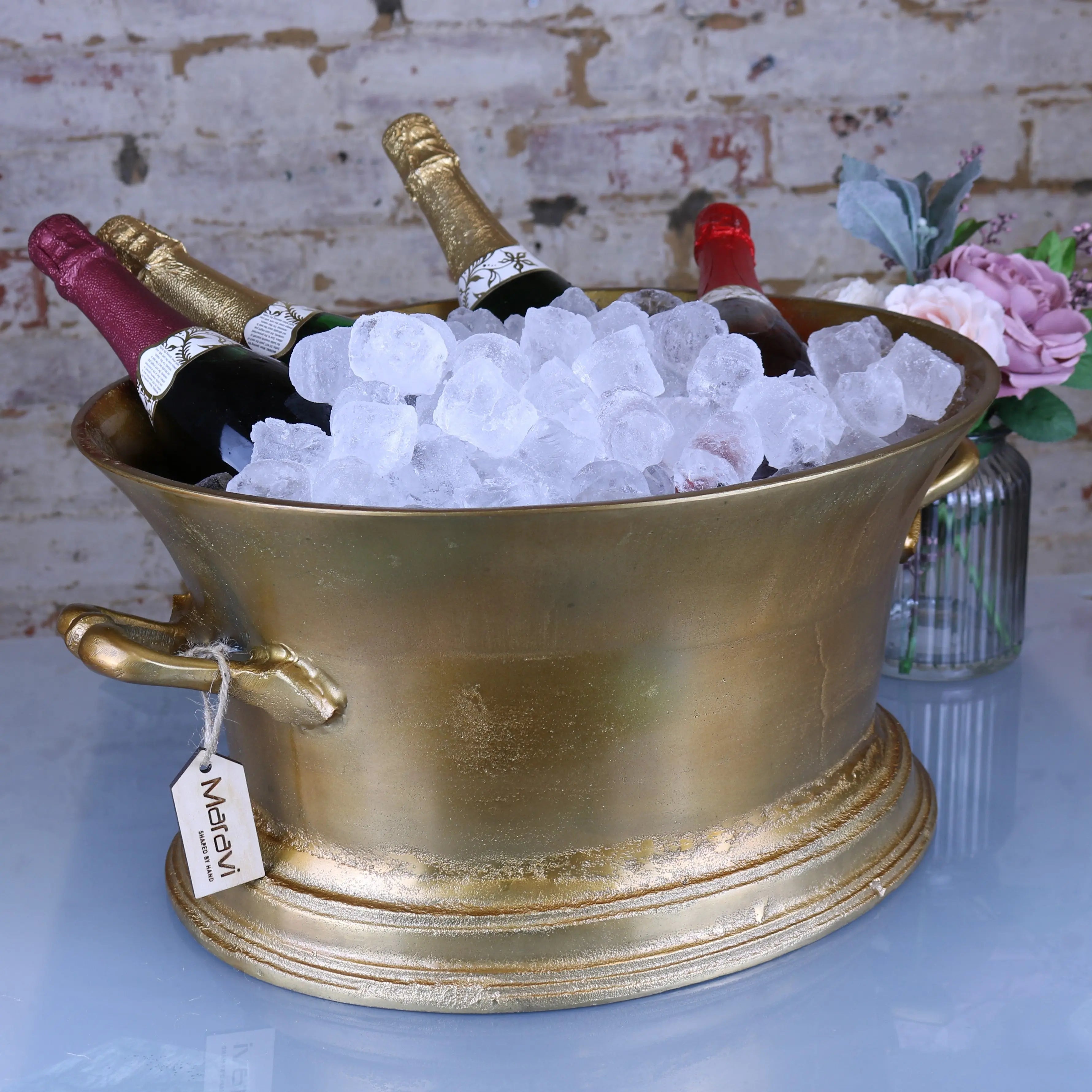 Gold-colored ornate moyar champagne bucket with two handles and tag large ice bath in distressed gold finish
