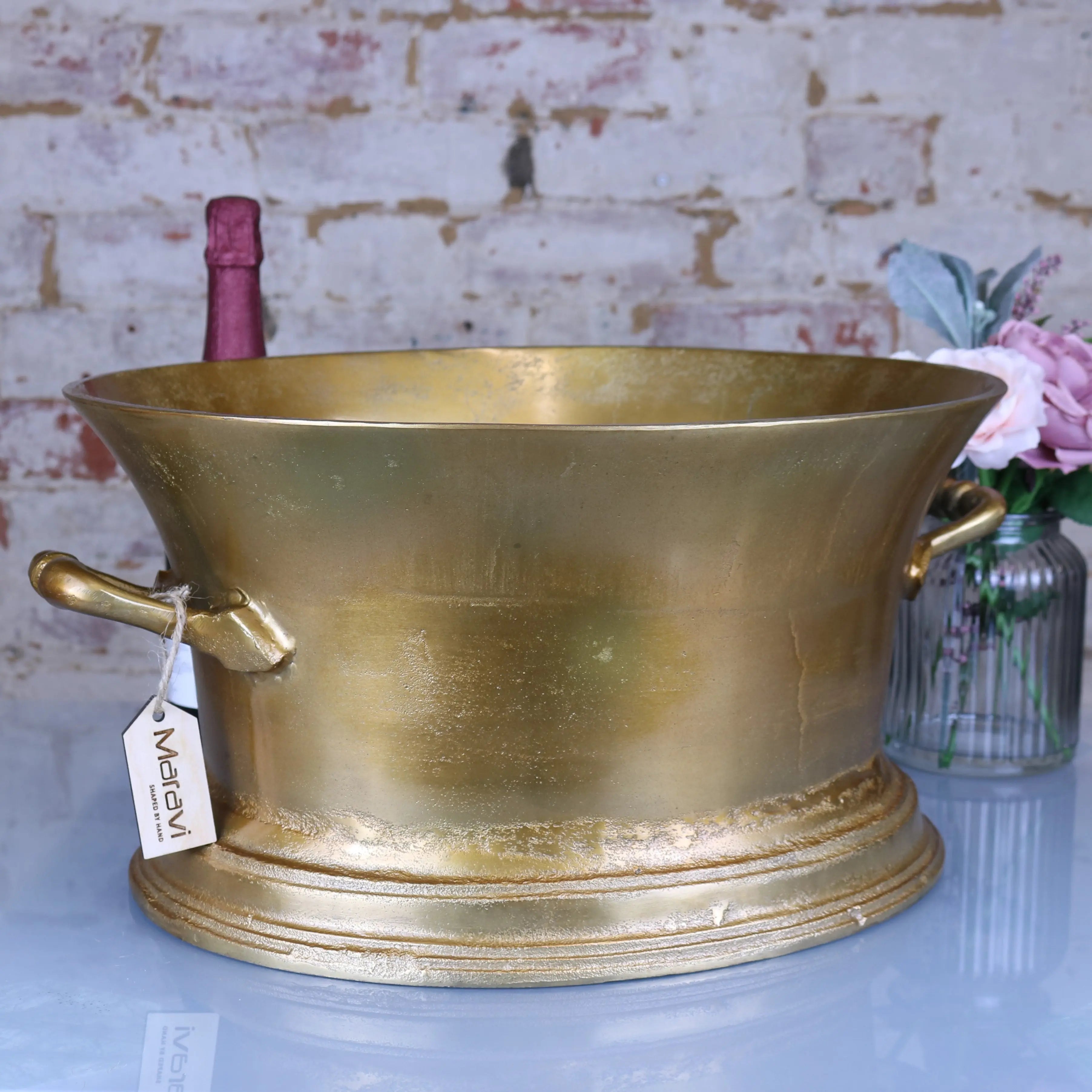 Golden brass moyar champagne bucket with two handles and decorative base perfect for large ice bath use