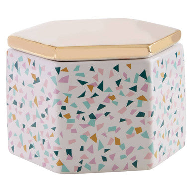A hexagonal ceramic mozio terrazzo pattern storage jar with pastel pink teal and mustard triangles and a gold-toned lid