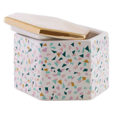 A hexagonal ceramic pattern storage jar with pastel terrazzo pattern and gold-trimmed lid for stylish storage