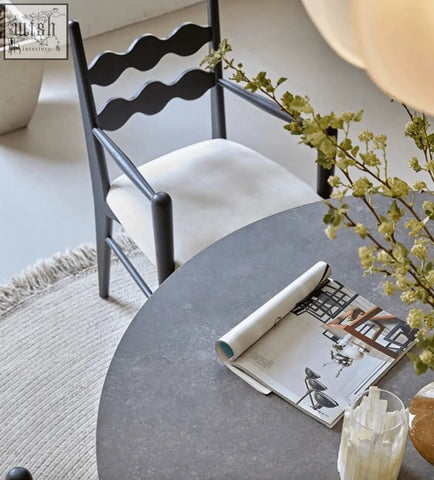Black wavy-back mucha dining chair with white upholstered seat perfect for stylish dining spaces