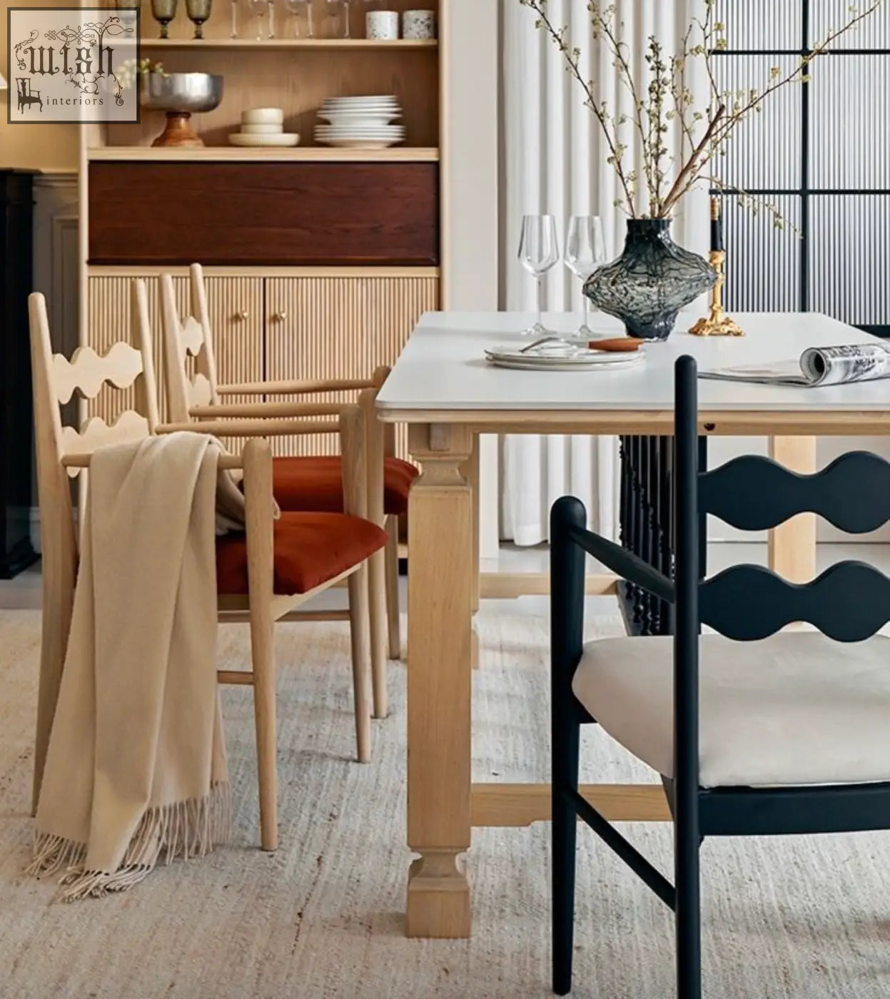 Dark blue wavy-back mucha dining chair with cream-colored cushion perfect for stylish dining spaces