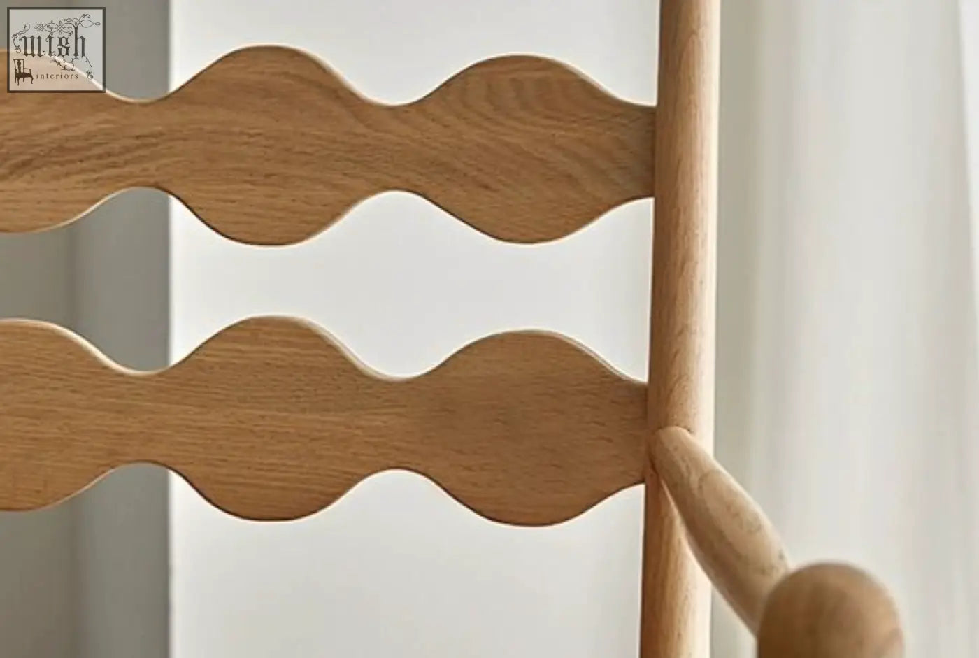 Back of light-colored wooden mucha dining chair with wavy scalloped slats and smooth vertical post