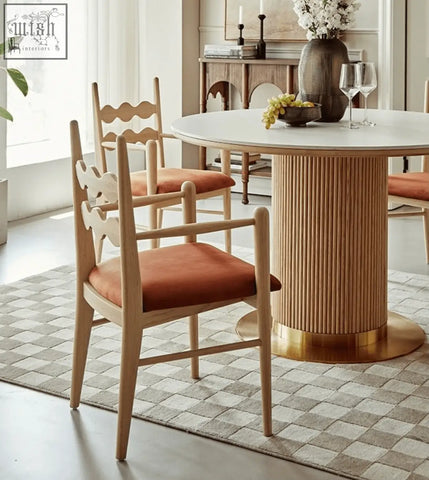 Light wood mucha dining chair with warm orange upholstered seat and wavy backrest design for dining room use