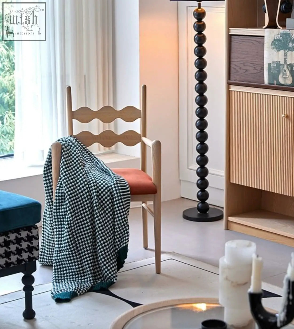 Light wood mucha dining chair with wavy backrest orange seat and teal white houndstooth blanket draped over it