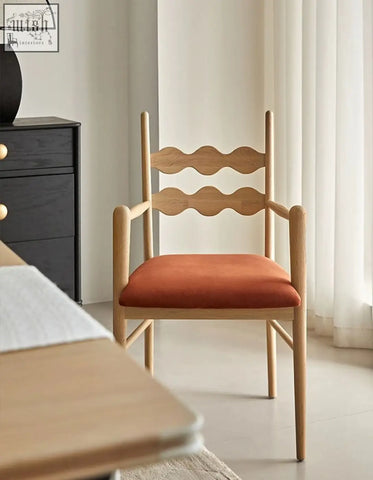 Light wood mucha dining chair with wavy backrest and orange upholstered seat for stylish dining spaces