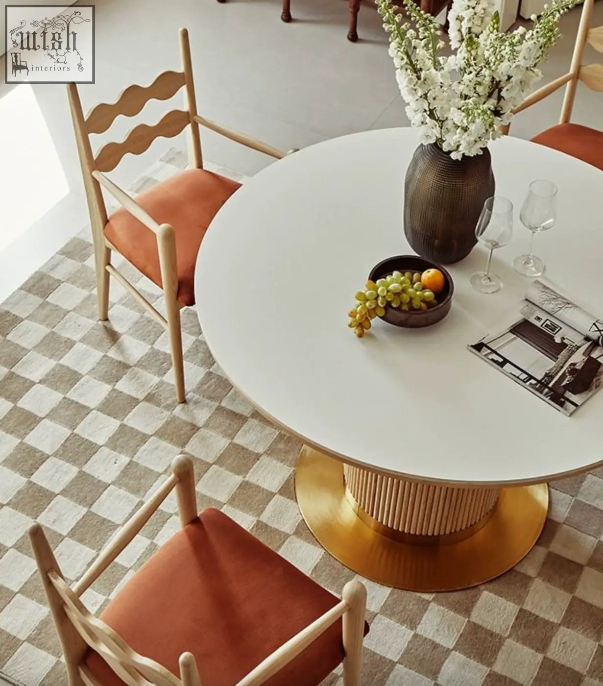White round dining table with gold ribbed pedestal base complements the mucha dining chair minimalist design