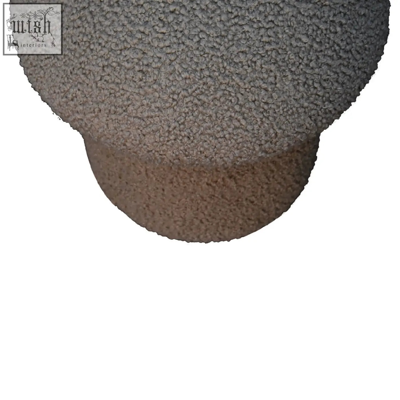 A two-toned gray and beige ceramic vase with a rounded shape paired with a mud boucle mushroom footstool