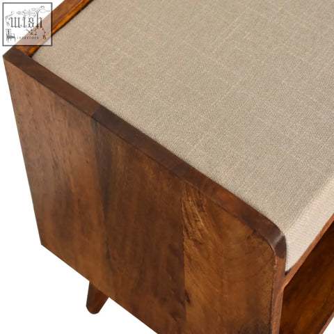 A mud linen nordic storage bench in chestnut wood with a beige linen cushion and rounded edges for hidden storage