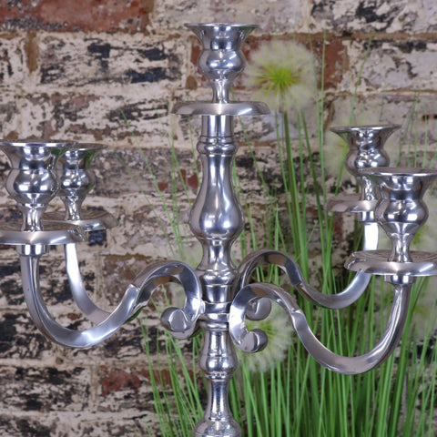 Silver candelabra with ornate curved arms and polished metallic finish from mula polished silver centerpiece 105cm