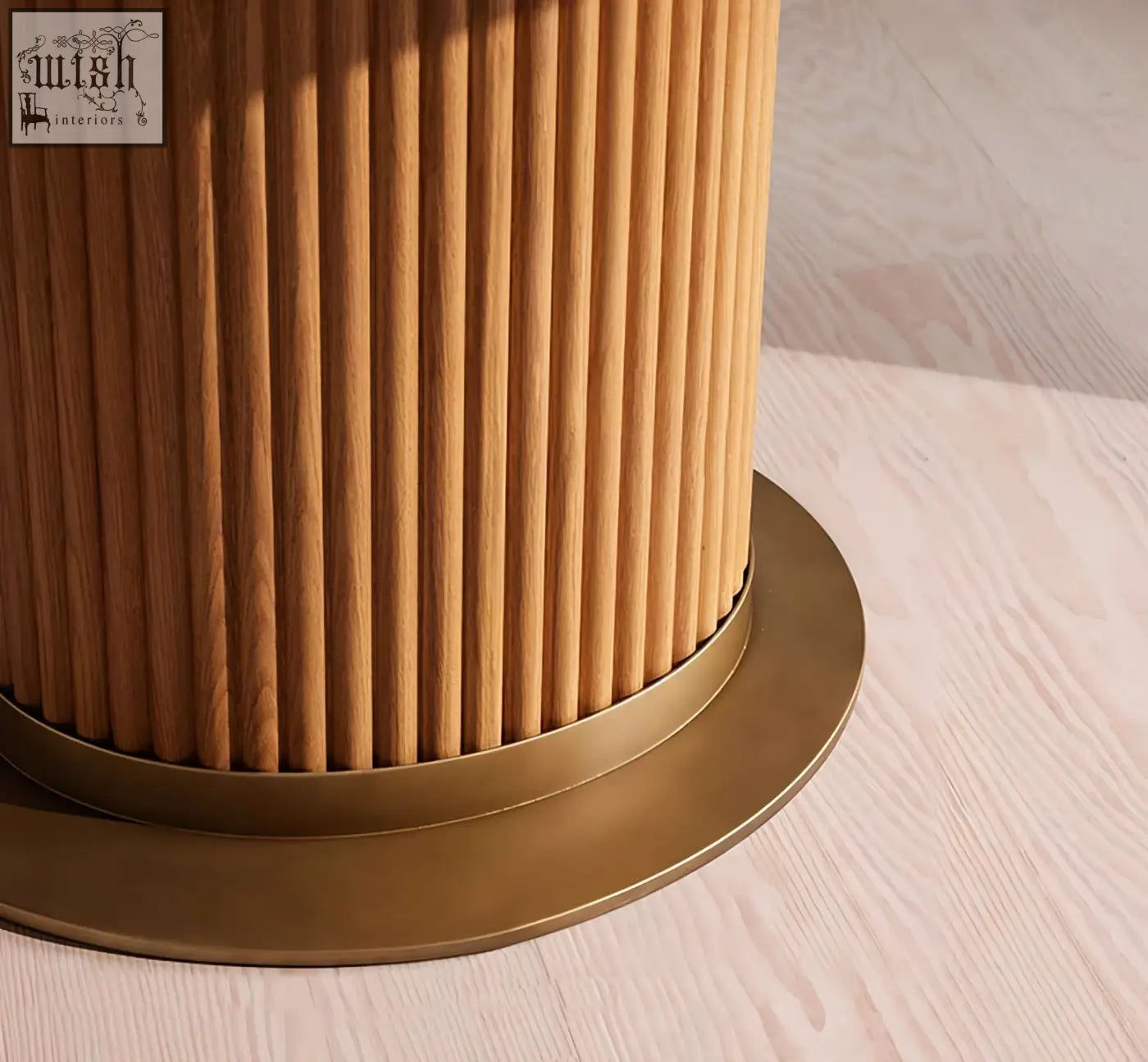 Cylindrical wooden table base with vertical slats and brass foot for murcell oval dining table with brazilian blue marble