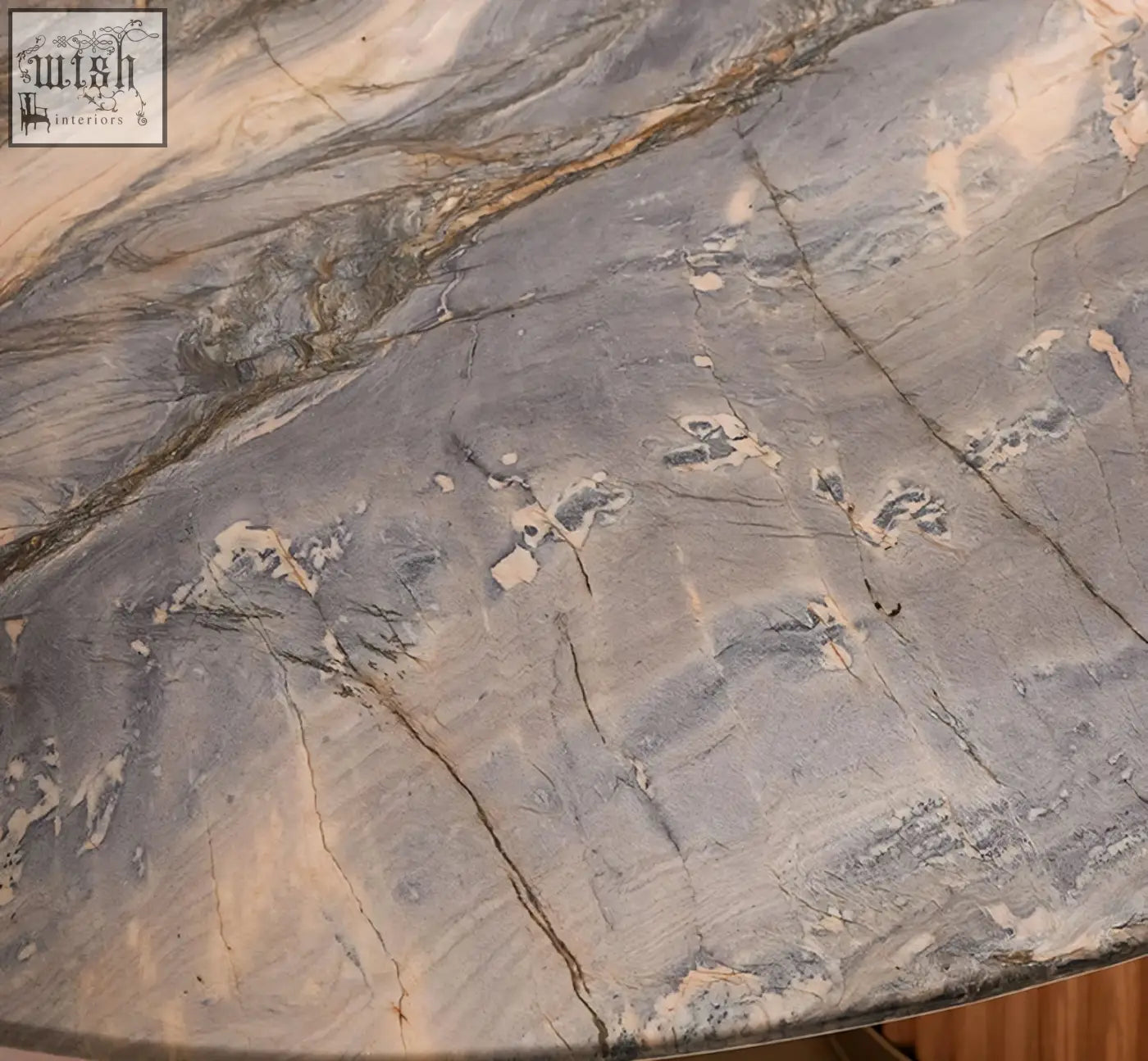 Gray marble tabletop with swirling beige and brown veining on murcell oval dining table in brazilian blue marble